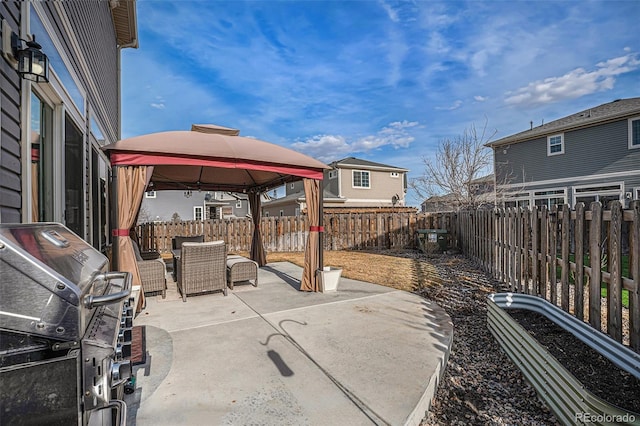 view of patio / terrace with area for grilling, a fenced backyard, and a gazebo