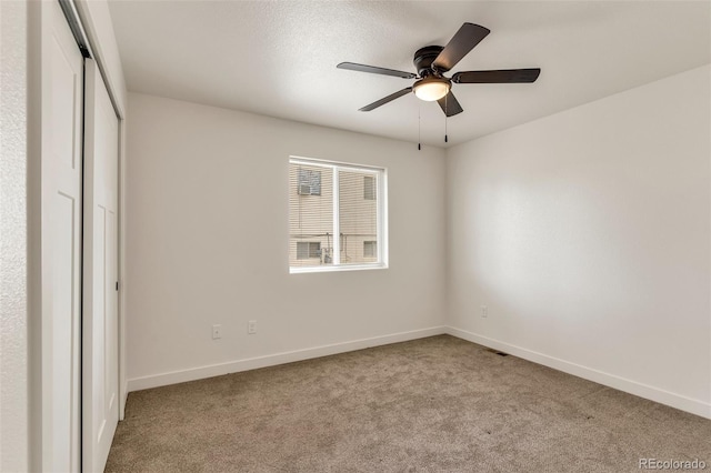 unfurnished bedroom featuring carpet, visible vents, baseboards, and a closet