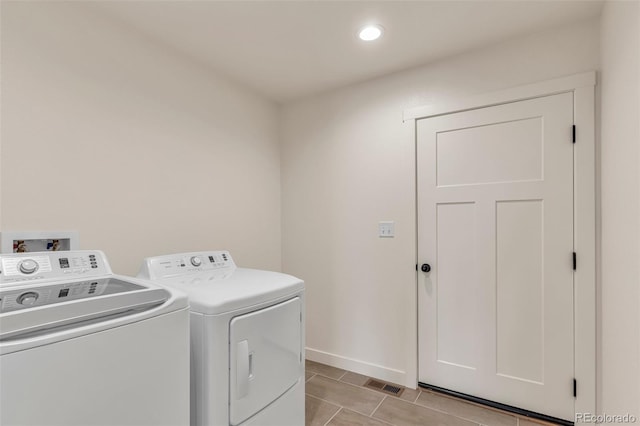 laundry room featuring laundry area, light tile patterned floors, baseboards, visible vents, and independent washer and dryer