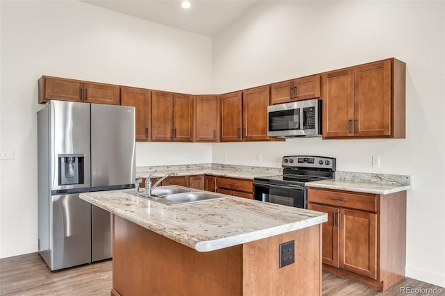 977 S Harmony Dr Unit 979, Pueblo, CO 81007 - kitchen with stainless steel appliances, a sink, baseboards, light wood finished floors, and a high ceiling