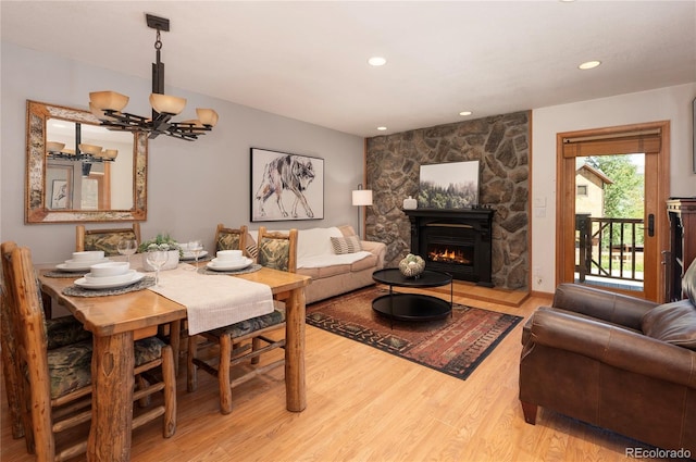 490 Kings Crossing Rd Unit 412, Winter Park, CO 80482 - dining room featuring light wood-style floors, a chandelier, a stone fireplace, and recessed lighting