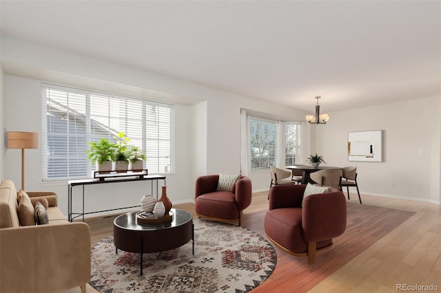 living room featuring a chandelier and light hardwood / wood-style floors