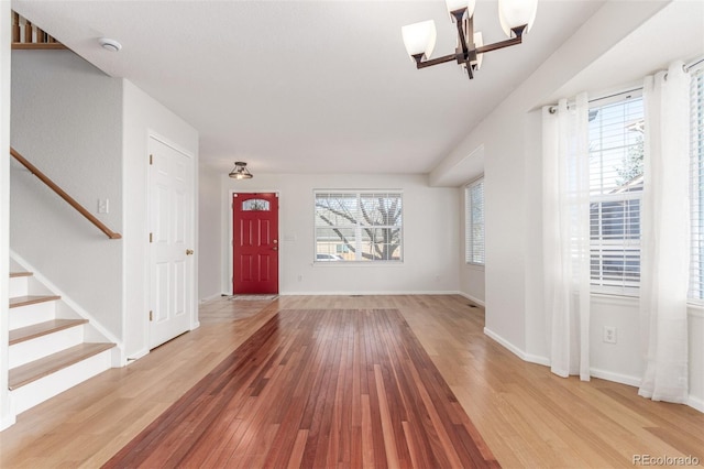 foyer entrance featuring a notable chandelier and light hardwood / wood-style flooring