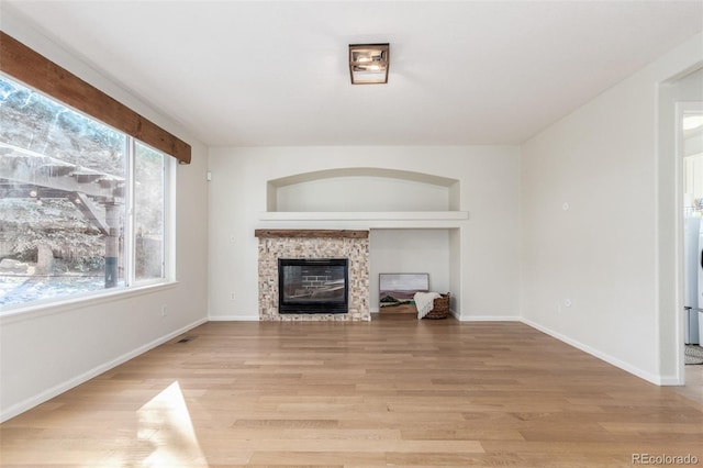 unfurnished living room with light hardwood / wood-style flooring and built in features