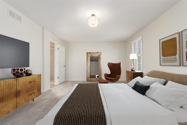 bedroom with light colored carpet