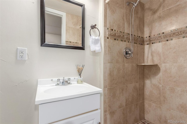 bathroom with vanity and tiled shower