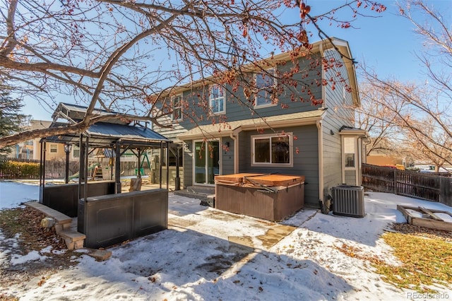 snow covered property featuring a gazebo, central AC, and a hot tub