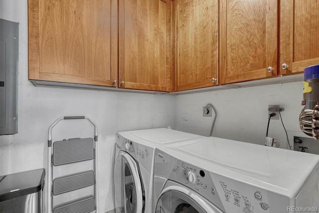clothes washing area with cabinet space, independent washer and dryer, and electric panel