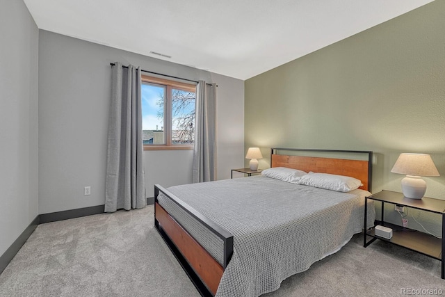 carpeted bedroom with visible vents and baseboards