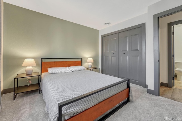 bedroom with light carpet, visible vents, baseboards, and a closet