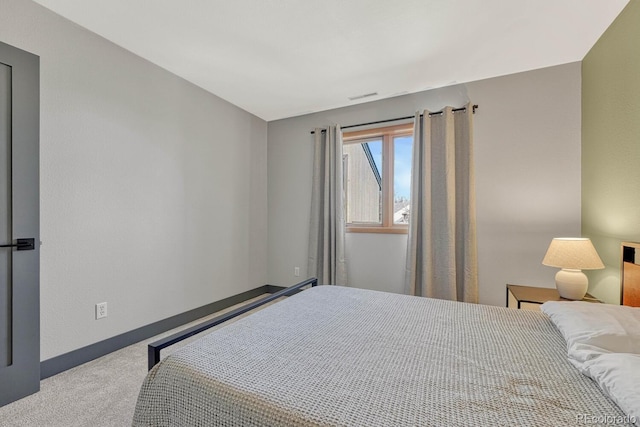 carpeted bedroom featuring visible vents and baseboards