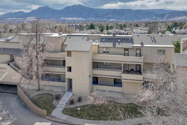 view of building exterior featuring a mountain view and a residential view