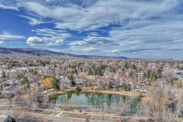 birds eye view of property with a water and mountain view