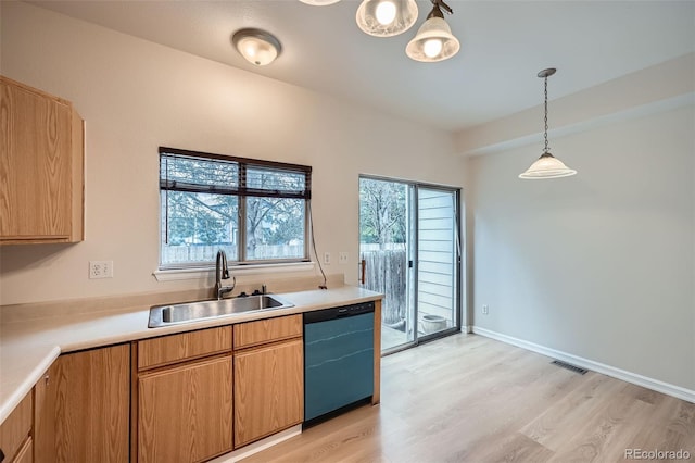 3033 W 107th Pl Unit D, Westminster, CO 80031 - kitchen featuring light countertops, a sink, dishwashing machine, and light wood-style floors