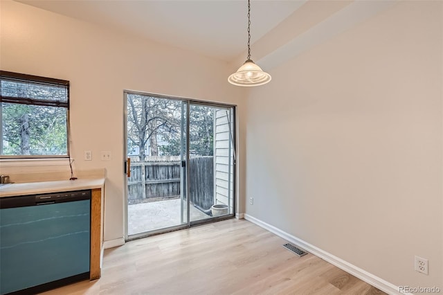 3033 W 107th Pl Unit D, Westminster, CO 80031 - unfurnished dining area with baseboards, visible vents, and light wood-style flooring