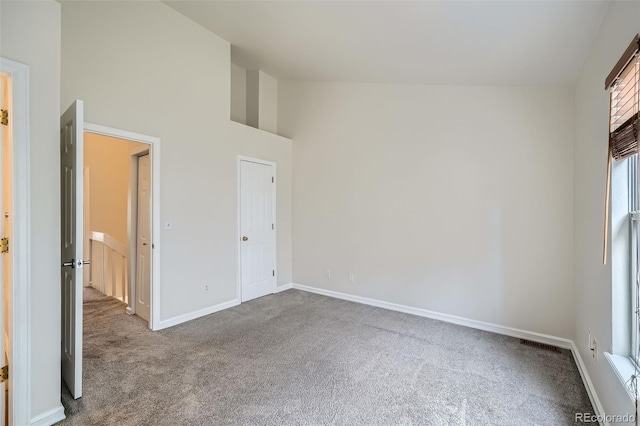 3033 W 107th Pl Unit D, Westminster, CO 80031 - unfurnished bedroom featuring carpet flooring, baseboards, visible vents, and high vaulted ceiling