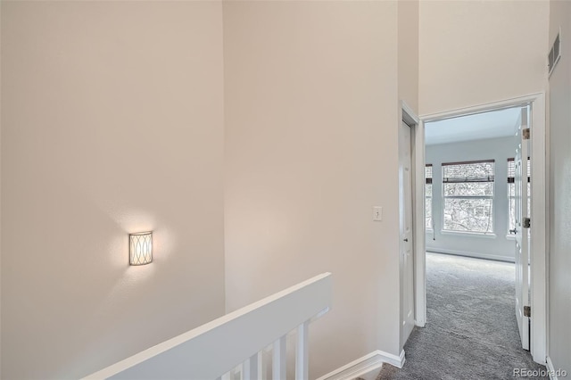 3033 W 107th Pl Unit D, Westminster, CO 80031 - hallway featuring dark carpet, baseboards, visible vents, and an upstairs landing