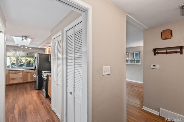 6077 Flower St, Arvada, CO 80004 - hall featuring dark wood-type flooring and baseboards