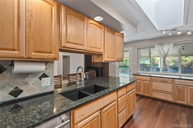 6077 Flower St, Arvada, CO 80004 - kitchen featuring plenty of natural light, dark wood-style flooring, dark stone countertops, and tasteful backsplash