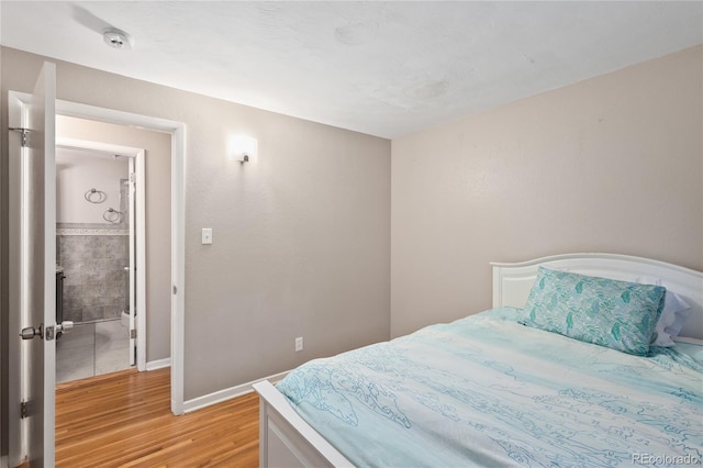 6077 Flower St, Arvada, CO 80004 - bedroom featuring light wood-type flooring and baseboards