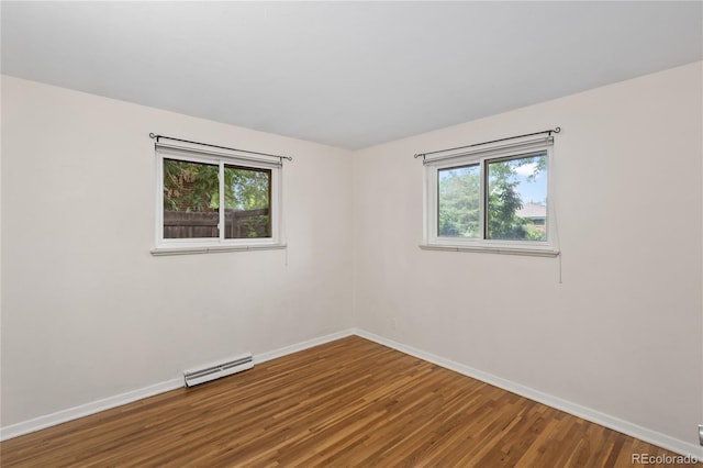 6077 Flower St, Arvada, CO 80004 - empty room featuring wood finished floors and a baseboard radiator
