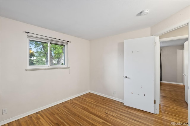 6077 Flower St, Arvada, CO 80004 - spare room with wood finished floors and a smoke detector