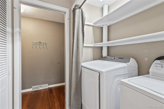 6077 Flower St, Arvada, CO 80004 - washroom with wood finished floors and washer and dryer