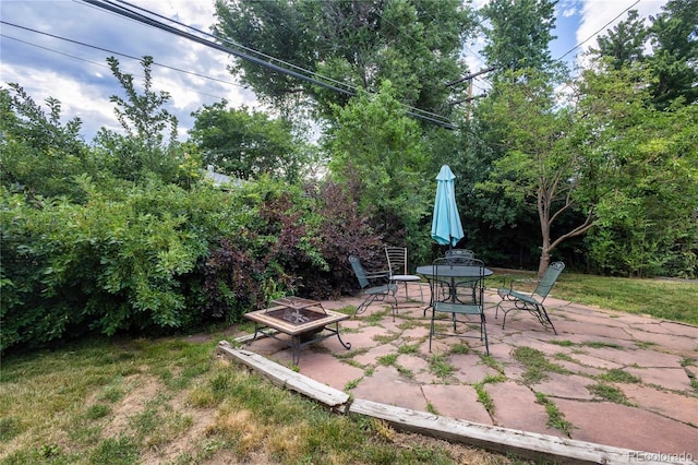 6077 Flower St, Arvada, CO 80004 - view of patio featuring a fire pit