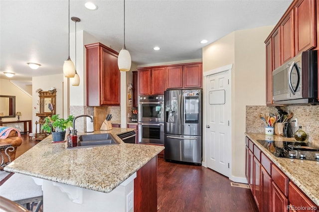 14119 W 89th Loop, Arvada, CO 80005 - kitchen featuring black appliances, a peninsula, dark brown cabinets, a breakfast bar area, and decorative backsplash