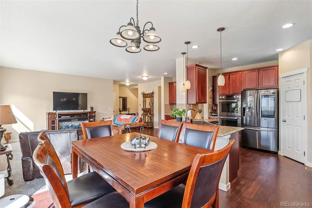 14119 W 89th Loop, Arvada, CO 80005 - dining area with dark wood-style flooring, a chandelier, and recessed lighting