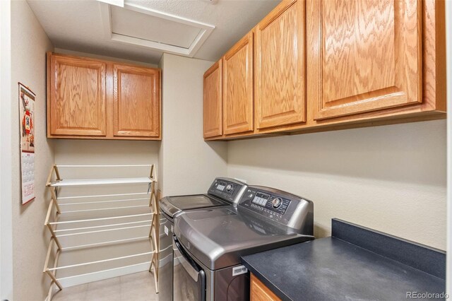 14119 W 89th Loop, Arvada, CO 80005 - laundry room featuring attic access, cabinet space, and washer and clothes dryer