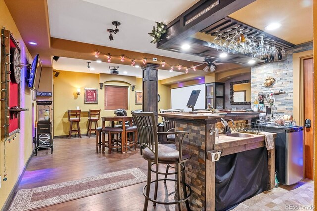 14119 W 89th Loop, Arvada, CO 80005 - indoor wet bar with wood finished floors, decorative columns, and recessed lighting