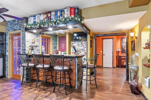 14119 W 89th Loop, Arvada, CO 80005 - indoor dry bar with ceiling fan, wood finished floors, and freestanding refrigerator