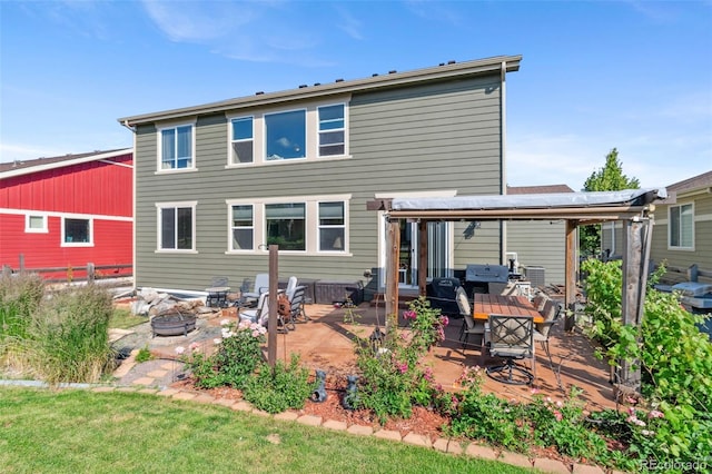 14119 W 89th Loop, Arvada, CO 80005 - rear view of property with an outdoor fire pit and a patio