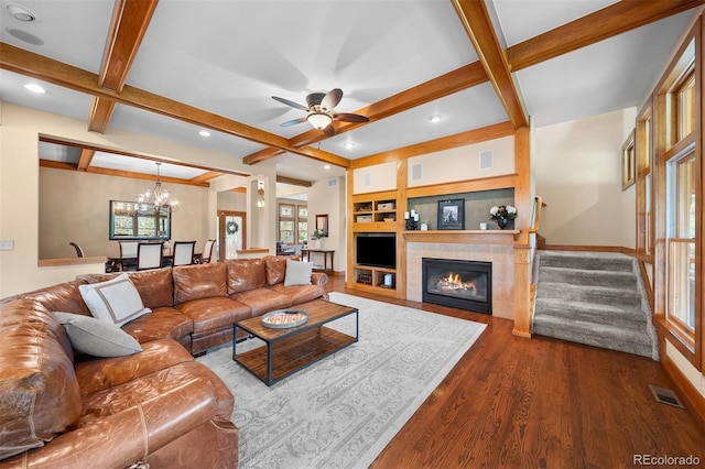 1122 Forest Trails Dr, Castle Pines, CO 80108 - living area featuring dark wood-type flooring, a tiled fireplace, beam ceiling, a ceiling fan, and coffered ceiling