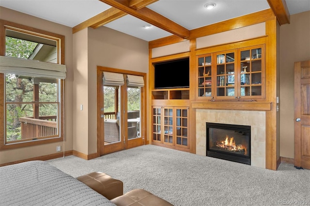 1122 Forest Trails Dr, Castle Pines, CO 80108 - carpeted living room featuring beamed ceiling, healthy amount of natural light, and a high end fireplace