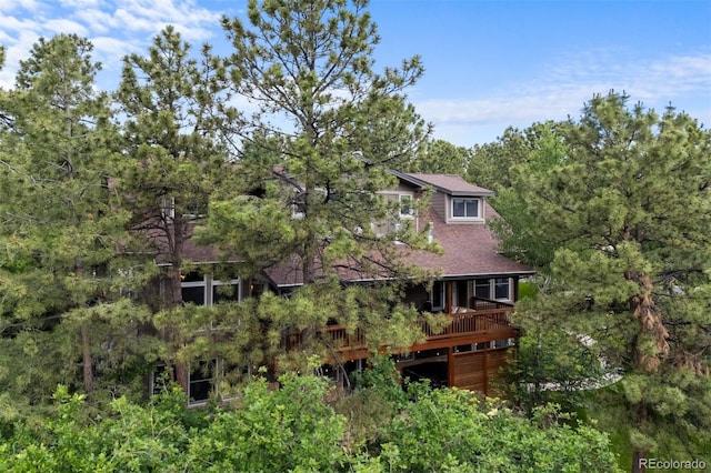 1122 Forest Trails Dr, Castle Pines, CO 80108 - rear view of property featuring a wooden deck, a forest view, and a shingled roof