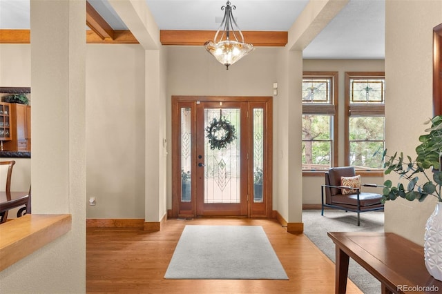 1122 Forest Trails Dr, Castle Pines, CO 80108 - entryway with wood finished floors, a chandelier, and beamed ceiling