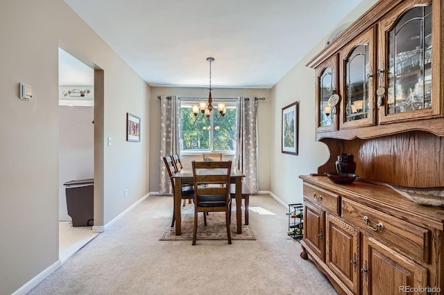 6857 S Franklin Cir, Centennial, CO 80122 - dining area with a chandelier, light carpet, and baseboards