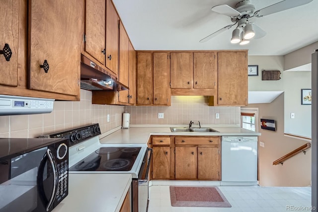 6857 S Franklin Cir, Centennial, CO 80122 - kitchen with white dishwasher, under cabinet range hood, a sink, electric stove, and tasteful backsplash