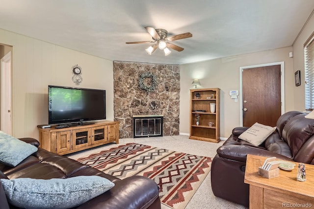 6857 S Franklin Cir, Centennial, CO 80122 - living room featuring a ceiling fan, a stone fireplace, and light carpet
