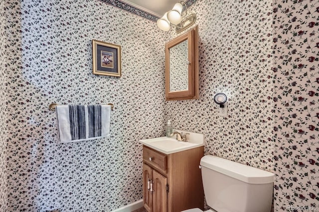 6857 S Franklin Cir, Centennial, CO 80122 - bathroom with toilet, vanity, and wallpapered walls