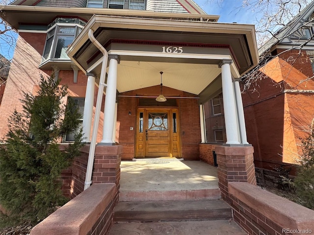 doorway to property with brick siding