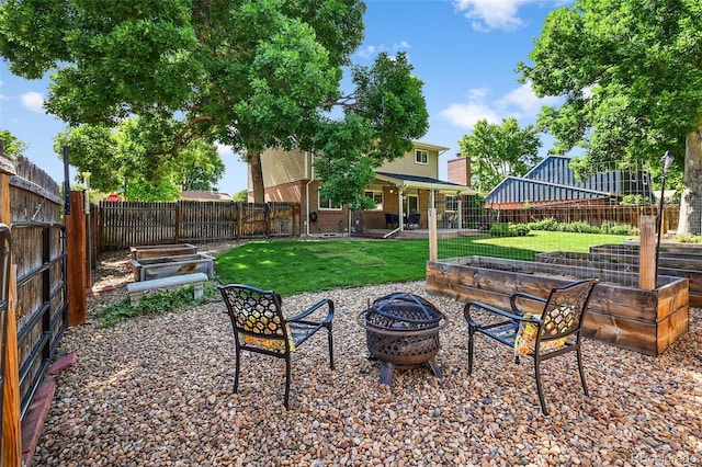 7486 S Washington St, Centennial, CO 80122 - fenced backyard featuring a vegetable garden, an outdoor fire pit, and a patio area