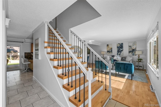 7486 S Washington St, Centennial, CO 80122 - stairway featuring a textured ceiling and tile patterned floors