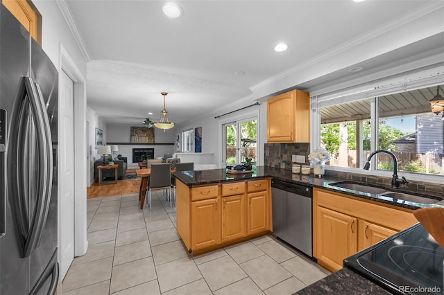 7486 S Washington St, Centennial, CO 80122 - kitchen featuring appliances with stainless steel finishes, light tile patterned floors, recessed lighting, crown molding, and a fireplace