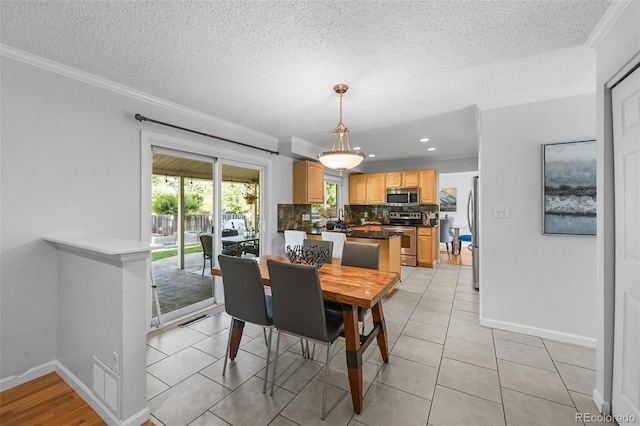 7486 S Washington St, Centennial, CO 80122 - dining space with crown molding, a textured ceiling, recessed lighting, and light tile patterned floors