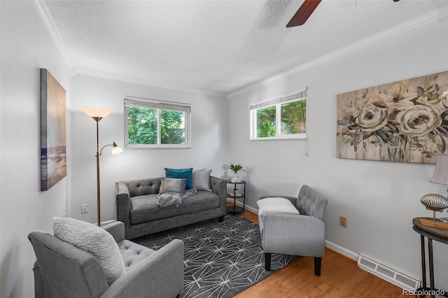 7486 S Washington St, Centennial, CO 80122 - living room featuring a textured ceiling, wood finished floors, plenty of natural light, crown molding, and ceiling fan