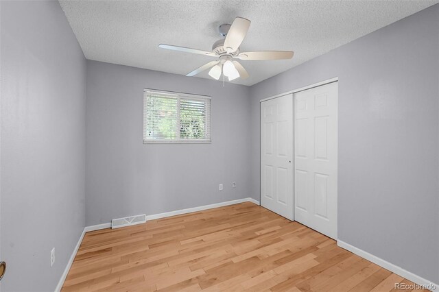 7486 S Washington St, Centennial, CO 80122 - unfurnished bedroom featuring light wood-style floors, a textured ceiling, a closet, and a ceiling fan