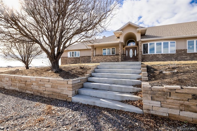 view of front of property with brick siding and stucco siding